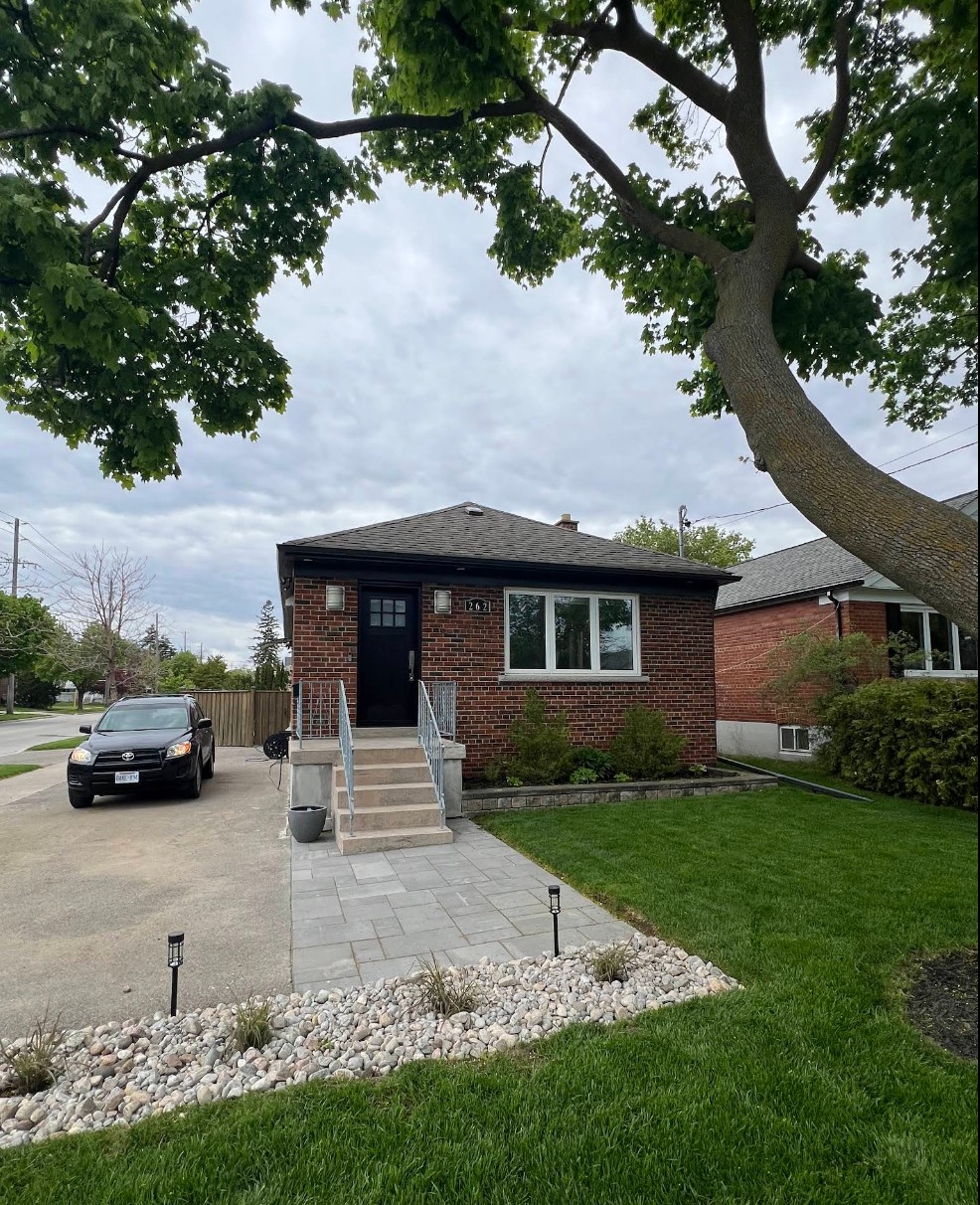Alderwood project — Toronto front yard with new paver walkway, river-rock garden bed, and freshly trimmed lawn